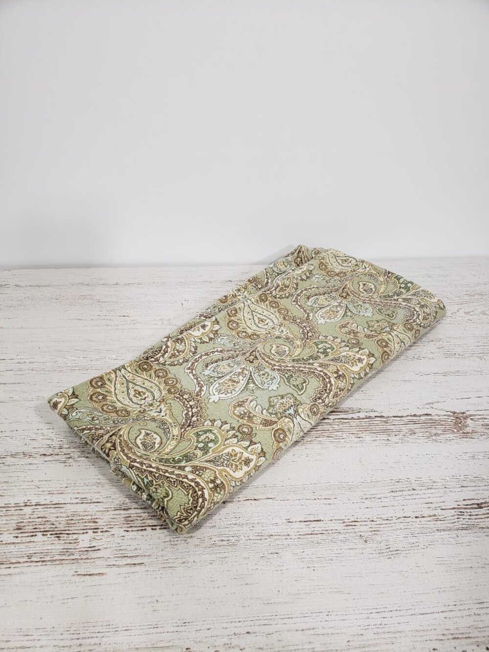 Cotton Paisley Green & Brown Round Tablecloth  folded in half it measures 68"